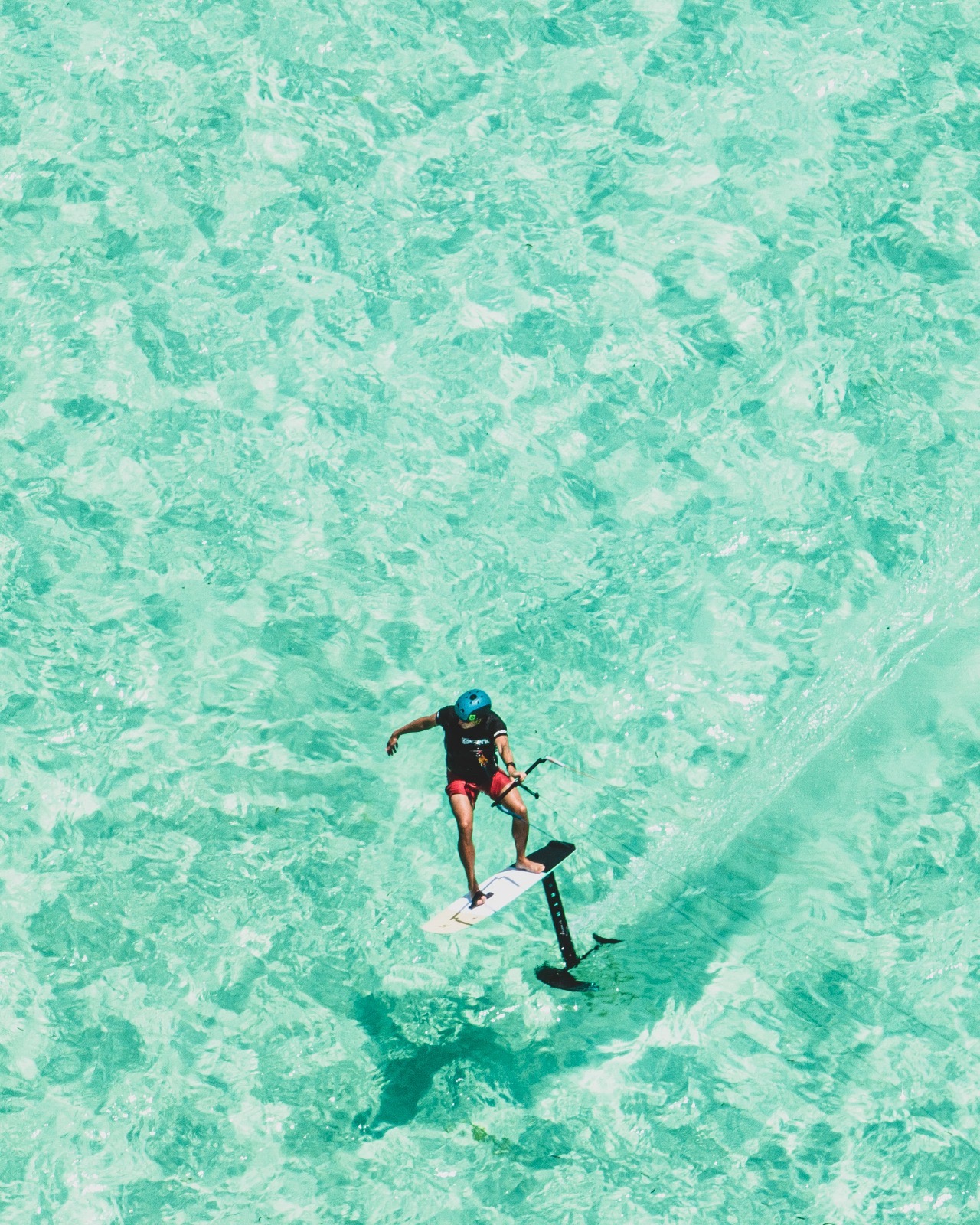 Matt Leta hydrofoil surfing in turquoise water