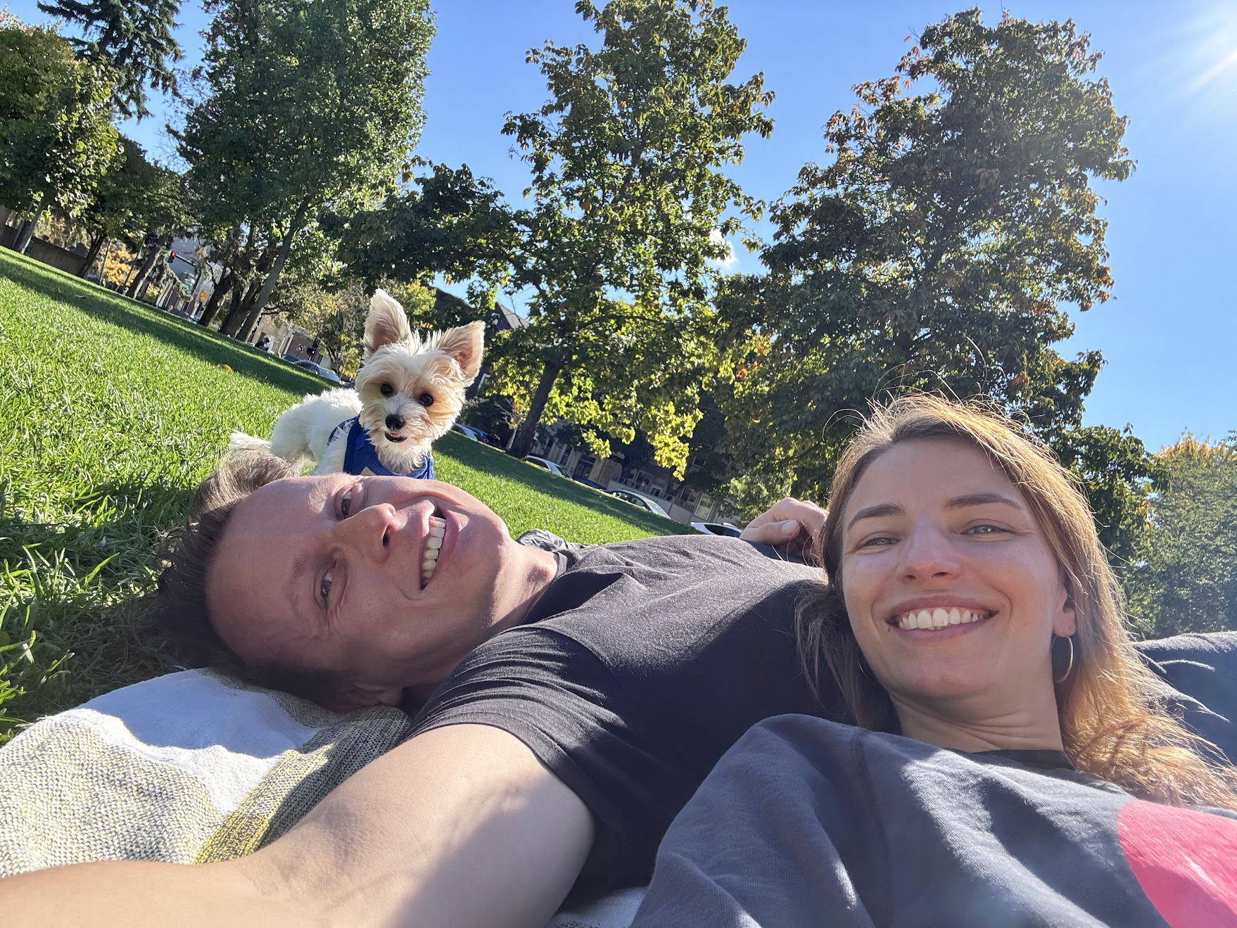 Matt Leta relaxing in park with partner and dog